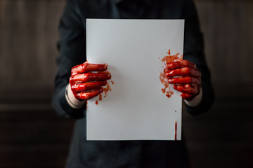 Bloody Red Hands Holding A Blank Piece Of Paper 