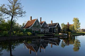 Fototapeta na wymiar Houses along a canal in Zaanse Schans during sunrise, The Netherlands