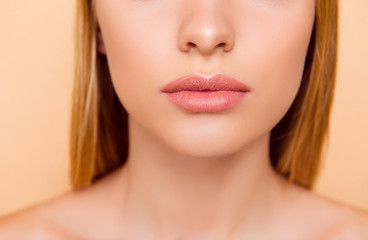 Close up cropped half face portrait of attractive, nude, natural, perfect, ideal girl with soft, healthy smooth lips isolated on beige background, perfection, wellness, wellbeing concept