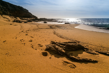Footprints runs into the sand on the sardinian beach of Gutturu and Flumini.