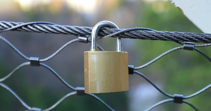 Padlock attached to grid. Love lock attached to bridge2