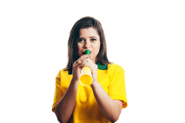 Brazilian fan cheering with a plastic horn isolated on white background