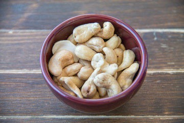 cashew nuts on bowl on a wooden table