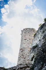 Naklejka premium Ruins of a medieval castle. Castle in Poland, watchtower. Old castle. A stronghold made of stone on the hill.