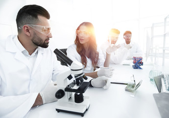 group of young scientists discussing the results of a study