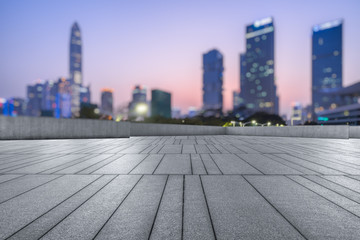 Panoramic skyline and buildings with empty square floor at dusk