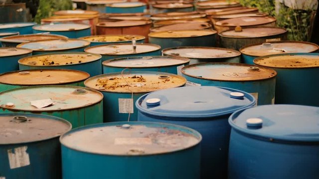 Old rusty barrels with oil products casks