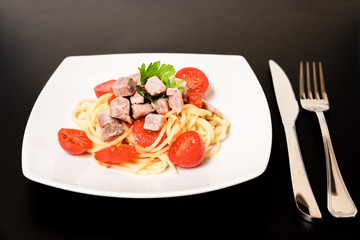 Spaghetti with sauce of Mediterranean tuna, Italian extra virgin olive oil, pepper, cherry tomatoes and a sprinkling of parsley