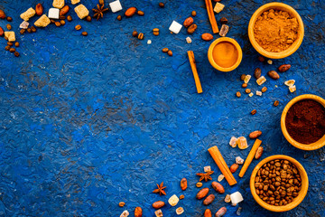 Flavouring products for making desserts. Cinnamon, cocoa, coffee on blue table top view space for text