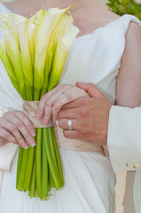 Groom holding the brides hand at wedding