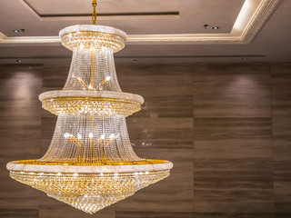 crystal chandelier shines hanging from the ceiling in the room