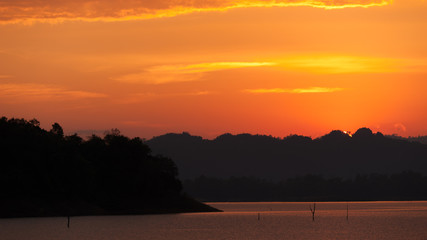 colorful dramatic sky with cloud at sunset. over silhouette mountains