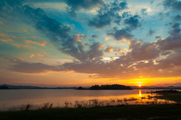 colorful dramatic sky with cloud at sunset. over silhouette mountains