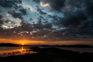 colorful dramatic sky with cloud at sunset. over silhouette mountains