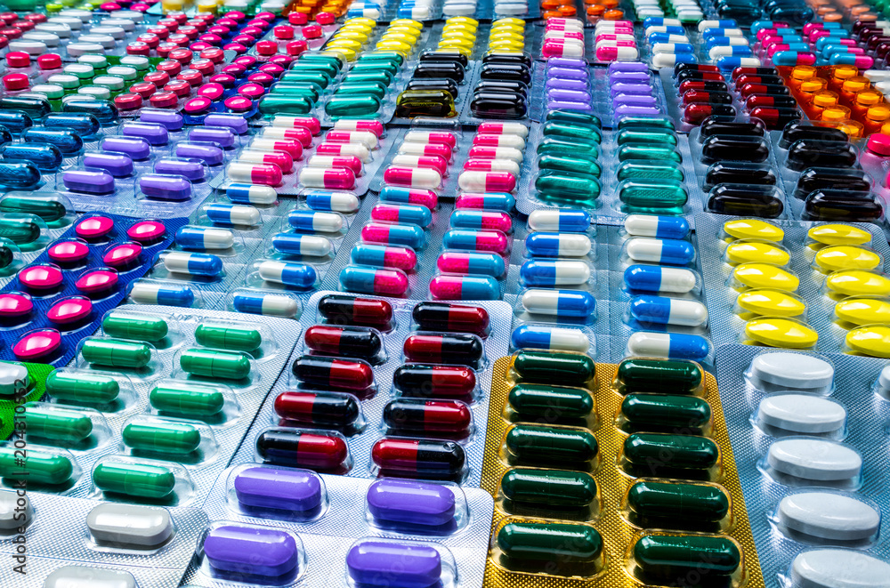 Wall mural colorful of tablets and capsules pill in blister packaging arranged with beautiful pattern. pharmace