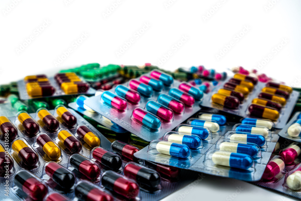 Wall mural pile of antibiotic capsule pills in blister pack isolated on white background with copy space. drug 