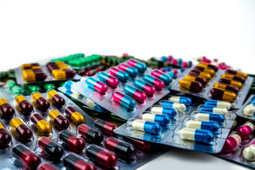 Pile of antibiotic capsule pills in blister pack isolated on white background with copy space. Drug resistance. Pharmaceutical packaging industry concept. Antibiotic resistance in hospital concept.
