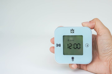 close up isolated hold digital alarm clock for setting