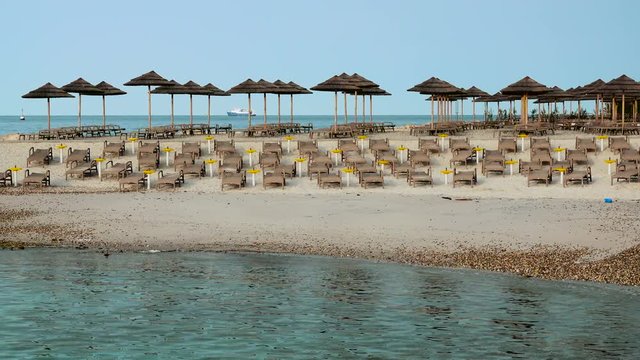 Beach with beach chairs in morning light on the beach