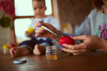 The mother and son painting Easter eggs