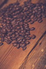 Coffee beans on old wooden table.