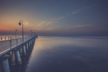 Fototapeta premium Amazing colorful sunrise over the pier in Gdynia Orlowo. Sunrise over the sea.