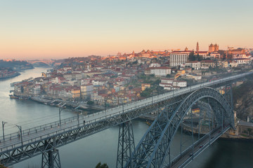 View of the historic city of Porto, Portugal with the ponte Dom Luiz bridge during sunrise. © Mazur Travel