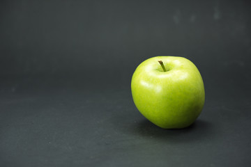 apple, green apple isolated on black background. Macro photography, fresh fruit, black paper