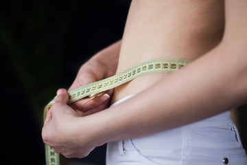 woman measures the volume of waist figure
