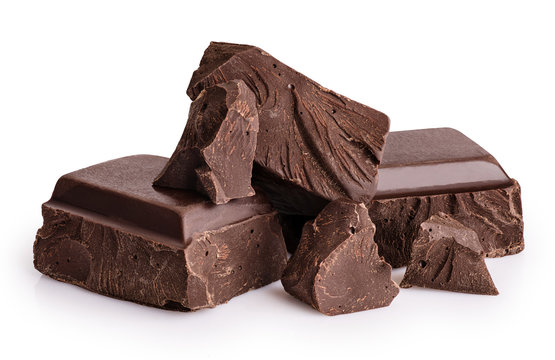 Naklejki Pieces of dark chocolate isolated on white background.