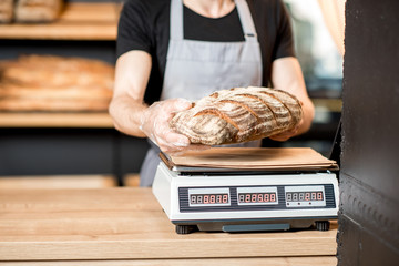 Seller weighting a bread loaf