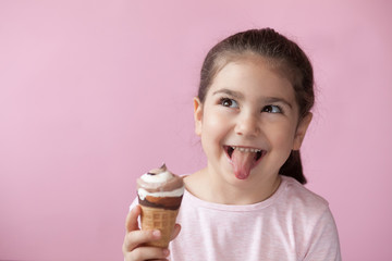 happy little girl with ice cream on a pastel background