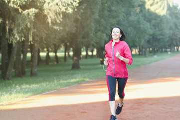 Portrait of elderly woman running in the park