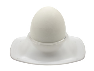white egg in egg cup isolated on white