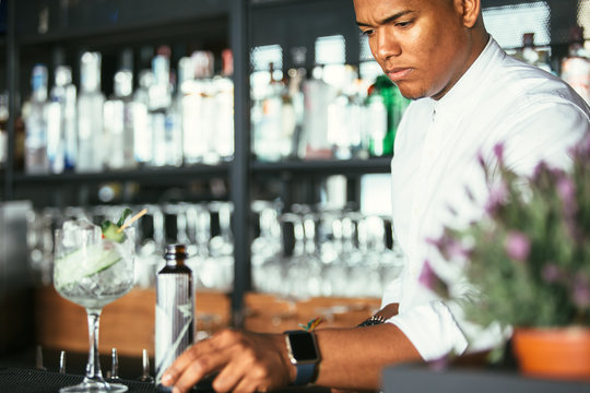 Expert male bartender with cocktail