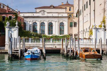 Beautiful building in Venice with boat and pier in the foreground