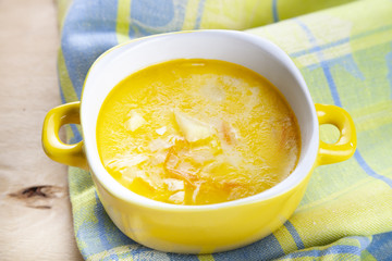 Cheese soup in a yellow plate