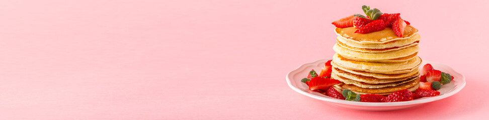 Pancakes with berries on a bright pastel background