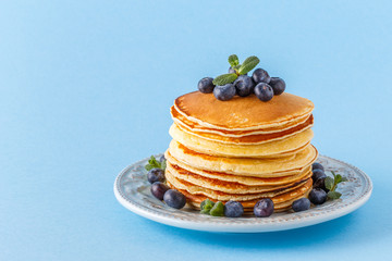 Pancakes with berries on a bright pastel background