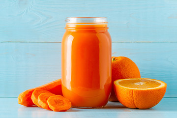 Orange-colored smoothies / juice in a jar