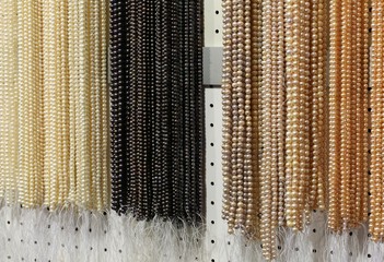 pearl necklaces arranged for sale  at a fair