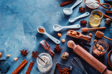 Baking utensils header. Measuring spoons, sea salt, eggs, flour, oil and sugar with whisks and cookie cutters on a modern concrete background with copy space. Making pastry concept.