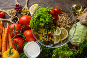 Healthy food background ,fruits and vegetables with salad bowl on wooden table.