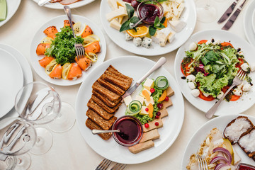 catering table set service with silverware and glass stemware at