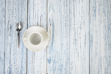 white coffe cup on light wooden background