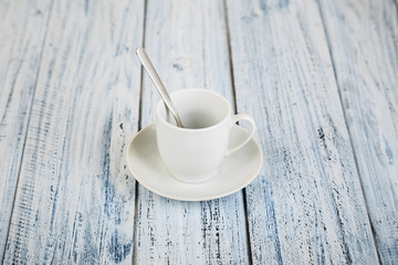 white coffe cup on light wooden background