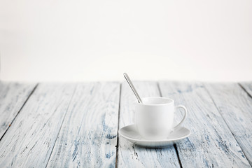 white coffe cup on light wooden background
