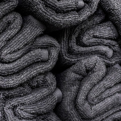 Stack of rolled gray towels. Close-up towels background. Texture.