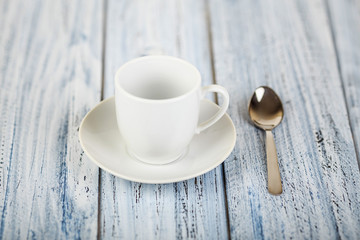 white coffe cup on light wooden background
