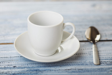 Obraz na płótnie Canvas white coffe cup on light wooden background